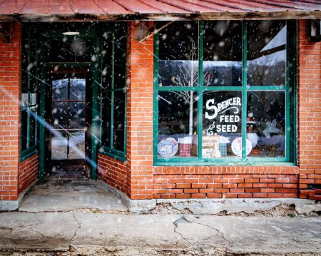 Photo for Snow flurries at the Feed and Seed Store at Spencer Station on historic Route 66 near Miller, Missouri. - Royalty Free Image
