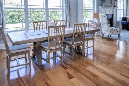 Photo for An open coastal dining room in a new construction shouse with wood floors. - Royalty Free Image