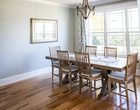 Photo for An open coastal dining room in a new construction shouse with wood floors. - Royalty Free Image