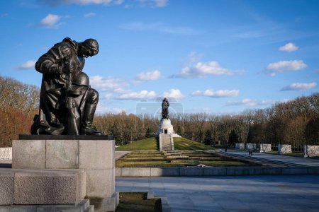 Berlin, Germany - March 28, 2023: Monument to a Soviet soldier with a sword holding a German child at the Soviet War Memorial in Treptower Park, Berlin, Germany. High quality photo