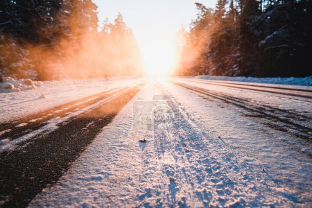 Snowy road outside the city. Ice on the highway on a cold winter day. Traffic in winter. High quality photo