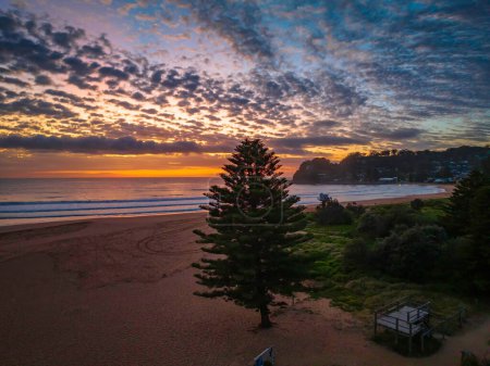 Foto de Salida del sol aéreo en la orilla del mar con nubes medianas que se extienden a través del cielo en Avoca Beach en la costa central, NSW, Australia. - Imagen libre de derechos