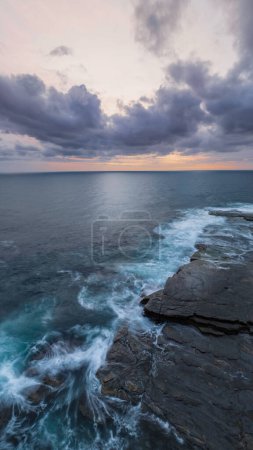 Photo for Aerial sunrise seascape with clouds at The Skillion in Terrigal, NSW, Australia. - Royalty Free Image