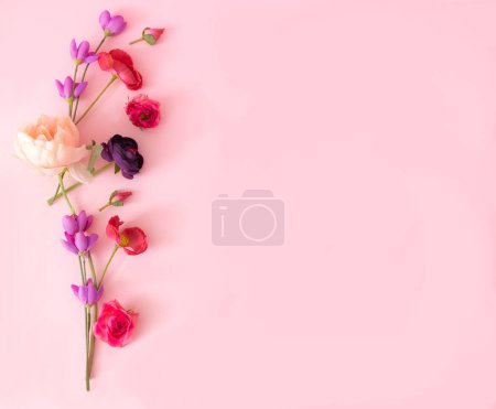 Photo for Pink, lilac and red flowers on the left side of pastel pink background. Floral design for birthday, wedding or engagement party invitation or card. Flat lay. Copy space. - Royalty Free Image