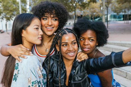 Photo for Cute multi-ethnic women and transgender person taking a selfie together in the city - Royalty Free Image