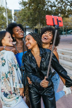 Photo for Vertical photo of friends having fun while taking a selfie outdoors - Royalty Free Image