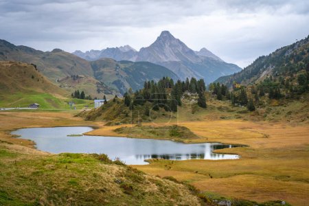 Photo for Walking along the wonderful mountain lake Kalbelesee in the alps at Hochtannberg with colorful plants in Vorarlberg, Austria - Royalty Free Image