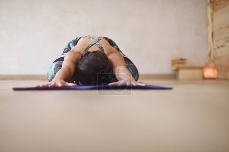 Photo for Woman on mat with arms and hands outstretched in yoga asana. Fondo de yoga - Royalty Free Image