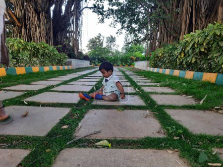 Photo for Bangalore, Karnataka, India-Jun 10, 2023: Closeup of beautiful Indian Toddler photo shoot in the park - Royalty Free Image