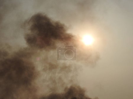 Closeup of beautiful mid day smoke and sun with sky background.