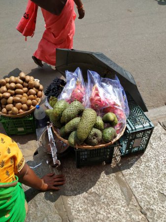 Photo for Closeup of beautiful Dragon Fruit, Kiwi and Guyabano or soursop fruit selling on wooden basket on roadside. - Royalty Free Image