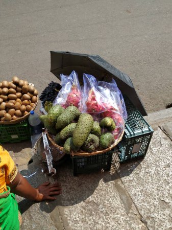 Closeup of beautiful Dragon Fruit, Kiwi and Guyabano or soursop fruit selling on wooden basket on roadside.