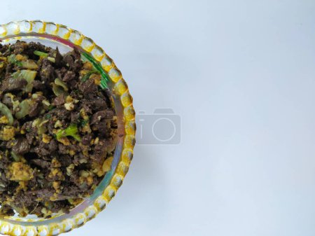 Closeup of Goat Blood Fry with Eggs in a cup isolated on white Background. Lamb Blood Fry in Village Style.