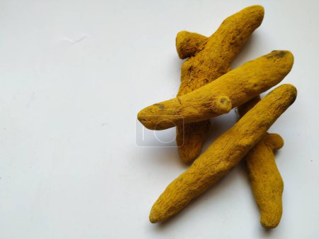 Group of Turmeric Roots isolated in a white Background. Turmeric is a spice comes from the turmeric plant. It is commonly used in Asian food. You probably know turmeric as the main spice in curry.