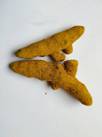 Group of Turmeric Roots isolated in a white Background. Turmeric is a spice comes from the turmeric plant. It is commonly used in Asian food. You probably know turmeric as the main spice in curry.