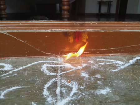 Closeup of Different types of Camphor Fire Flame in front of the door of house during puja time of Festival Season