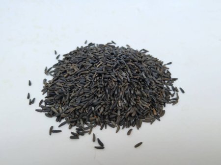 Closeup view of scattered niger seed with shallow depth of field. Pile and heap of Black Color Uchellu or Gurellu. These seeds are used in masalas by the people of North Karnataka.
