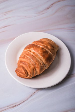 Photo for Croissant bread on a plate on a marble table. Food concept. - Royalty Free Image