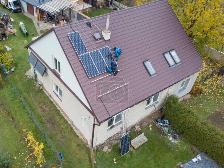 Photo for Installation of photovoltaic panels. Aerial view of the construction of the photovoltaic power plant of the family house. - Royalty Free Image