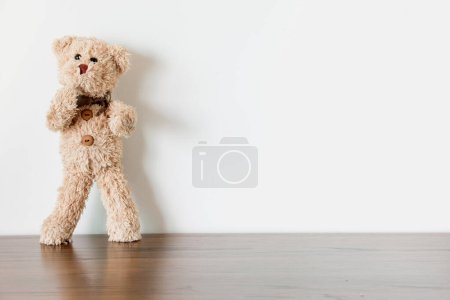 Photo for The cute teddy bear is stretching and balancing exercising at home. Healthy on quarantine concept. - Royalty Free Image