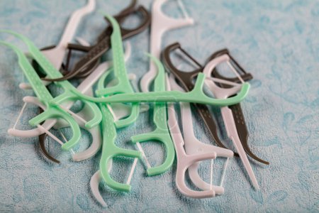 Photo for Colorful toothpick. Assorted colors dental floss pick on the color background. - Royalty Free Image