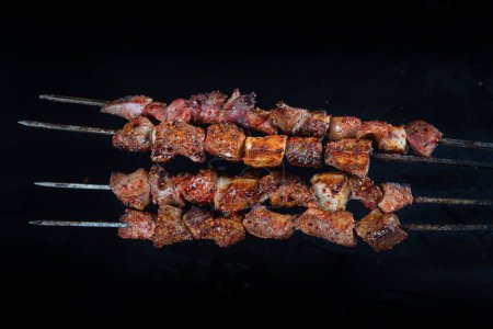 Photo for Liver kebab, one of Adana's special tastes. street flavors. Grilled beef liver on skewers, with teriyaki or soy sauce. Ciger kebab, table, liver on skewers. - Royalty Free Image