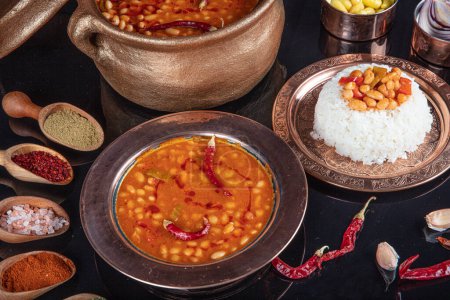 Photo for Turkish food on the table Baked bean pilaf (dark blue beans and rice). Local traditional foods concept with top view. Turkish foods; dried bean (kuru fasulye). - Royalty Free Image