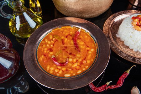 Photo for Turkish food on the table Baked bean pilaf (dark blue beans and rice). Local traditional foods concept with top view. Turkish foods; dried bean (kuru fasulye). - Royalty Free Image