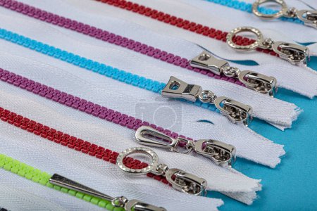 Photo for Colorful Resin Zippers with Ring Pulls for DIY Tailor Sewing Craft Accessories Mixed. Bright zipper of different colors and variants in the textile industry. - Royalty Free Image