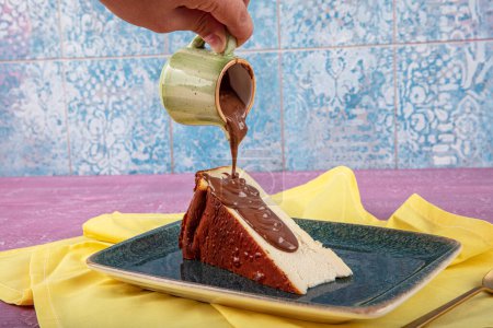 Photo for San Sebastian burnt cheesecake. Delicious homemade dessert. San Sebastian cheesecake with chocolate sauce. Pour the chocolate juice onto the san sebastian slice. - Royalty Free Image