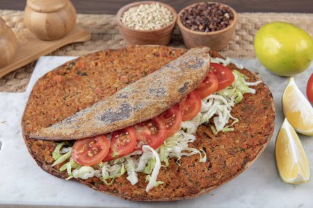 Lahmacun from buckwheat flour. Turkish dishes: lahmacun, turkish pizzas, lemon, parsley. Healthy eating, dieting, slimming and weigh loss concept.