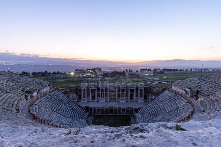 Amphitheater in ancient city of Hierapolis. Dramatic sunset sky. Unesco Cultural Heritage Monument. Pamukkale, Turkey