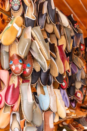 Sandal. 'Yemeni', a Traditional Hand Made Leather Shoes. Traditional turkish leather shoes named yemeni. Colorful handmade leather slipper shoes displayed on the street market in Turkey.