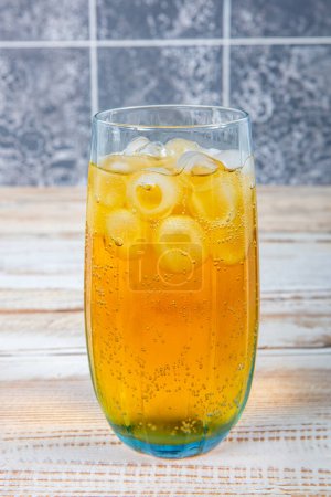 A glass of energetic drink consisting of energy drink and ice. Iced soda. Iced cold energetic drink. Sparkling drink. Iced soda.