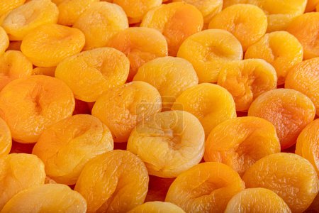Yellow Dried Apricots Arranged Symmetrically. Dried apricot fruit. Tasty dried apricots as background, top view. Healthy snack.