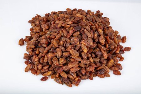Seeded yellow raisins (sultana), dried fruits. Dried yellow raisins in a copper bowl, raisins scattered around a copper bowl of raisins.