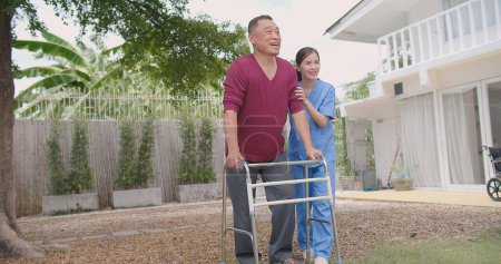 Asian Woman Nurse Supporting and Caring for Adult Male Patient Outdoors during the Recovery of Leg Injuries, Nurse Empowering Elderly Patients in their Recovery Journey