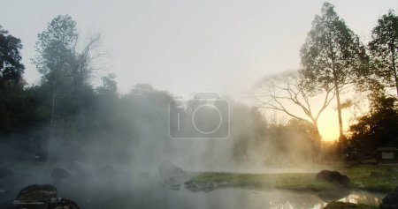 Beauty in nature Hot spring water Onsen Natural Bath with fog in the morning sunrise at Chae Son National Park, Lampang Thailand