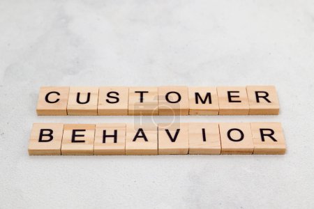Top view of Customer Behavior word on wooden cube letter block on white background. Business concept