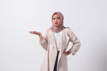 Téléchargez les photos : Portrait de femme hijab asiatique confus en costume décontracté écartant les mains latéralement, ressentant le doute tout en faisant un choix. Concept de femme d'affaires. Image isolée sur fond blanc - en image libre de droit