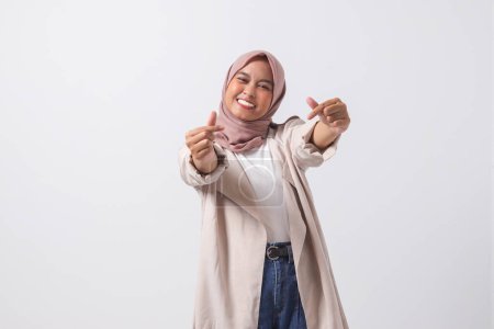 Téléchargez les photos : Portrait de femme asiatique excitée hijab en costume décontracté faire signe de coeur coréen signifie l'amour pour vous. Manifester de la sympathie et des sentiments bienveillants. Image isolée sur fond blanc - en image libre de droit