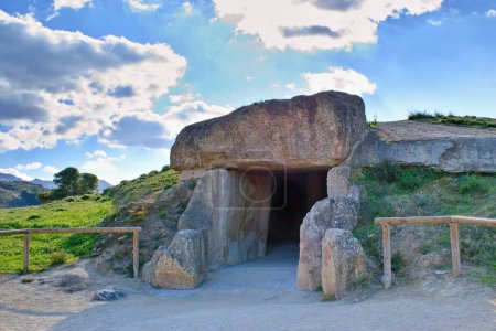 Dolmen de Menga - exterior of megalithic burial tumulus. One of the largest known ancient megalithic structures in Europe. UNESCO World Heritage Site, Antequera, Malaga, Spain.