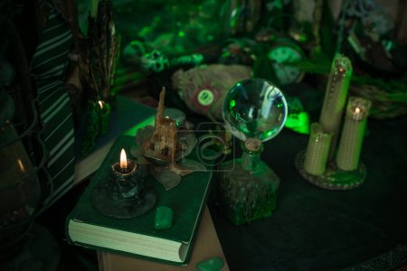 Illustration of magical stuff....candle light, book of spells, magical atmosphere, wizards school, green aesthetic, Halloween time