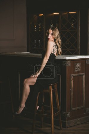 Photo for Portrait of pretty woman in a bar or club, concept of drinks, beverage - Royalty Free Image