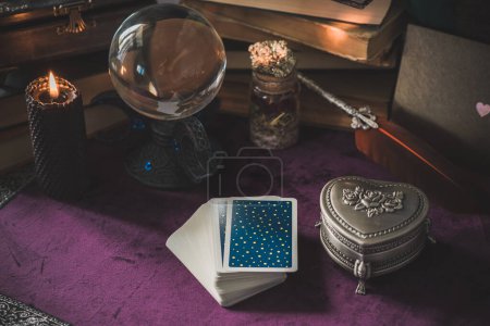 Tarot cards and candles, witch magic bottles . Wicca, esoteric, divination and occult background with vintage magic objects for mystic rituals