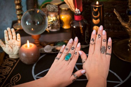 Téléchargez les photos : Signification des anneaux sur un doigt. Symbole ésotérique et astrologique de l'anneau. Scène avec une main de dames - en image libre de droit