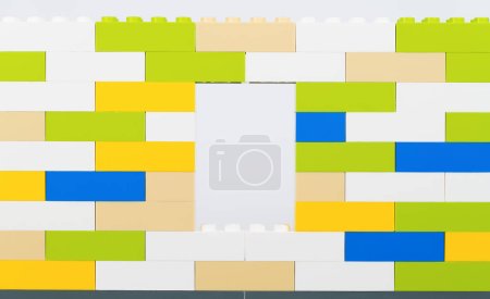 Colorful plastic bricks wall on white background.