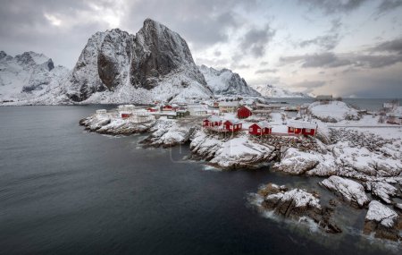 Photo for Winter View of Red Cabin in Fishing Village - Royalty Free Image