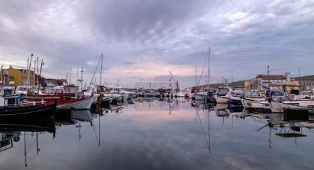 Photo for A harbor filled with lots of boats under a cloudy sky - Royalty Free Image