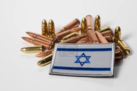 Israel flag with weapon ammunition. War between Israel and Lebanon. 7.62x39 rifle bullets ammunition. IDF military. Conflict situation and fighting. Crisis.